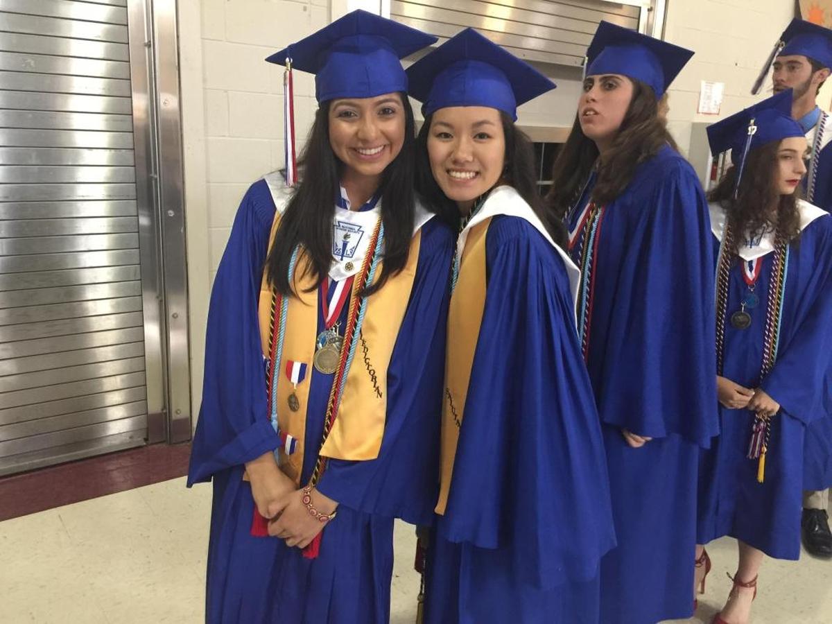 Pass Christian High School valedictorian Gnyata Patel and her friend, salutatorian Jennifer Hoang, strike a pose before the commencement service Friday, May 19, 2016.