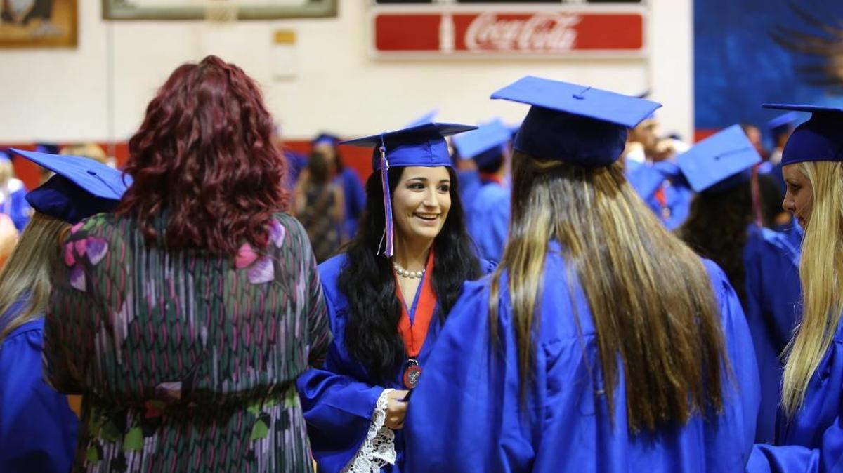 Madyson Daniels, center, talks with friends before Hancock High School graduation on Friday, May 19, 2017. Daniels was diagnosed with Hodgkin’s lymphoma about a month ago.