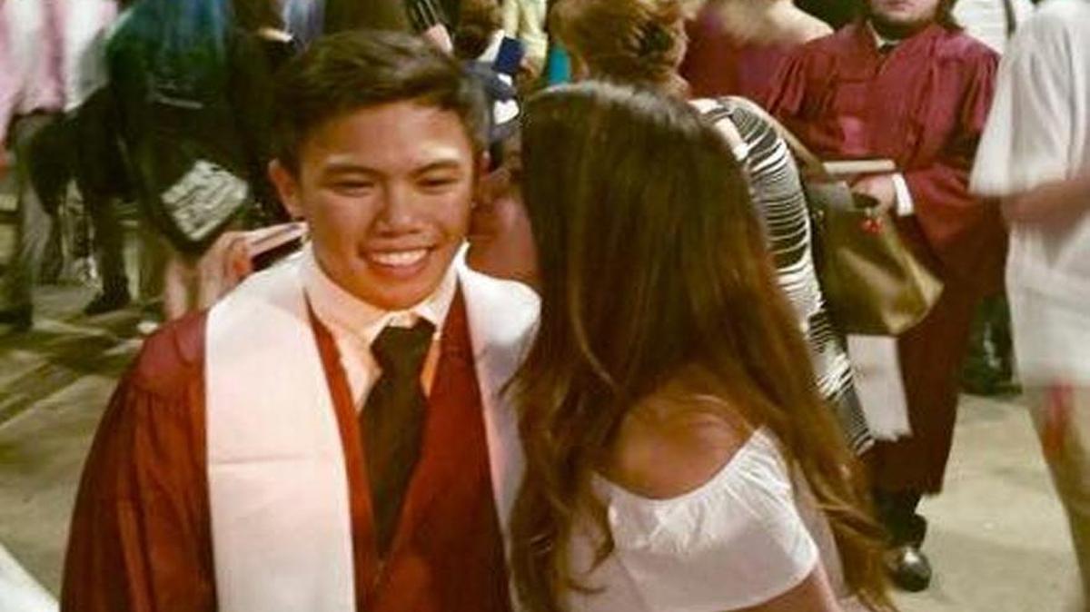 Sita La’Cap kisses her brother Noah La’Cap on the cheek after he graduated from Long Beach High School on May 18, 2017.