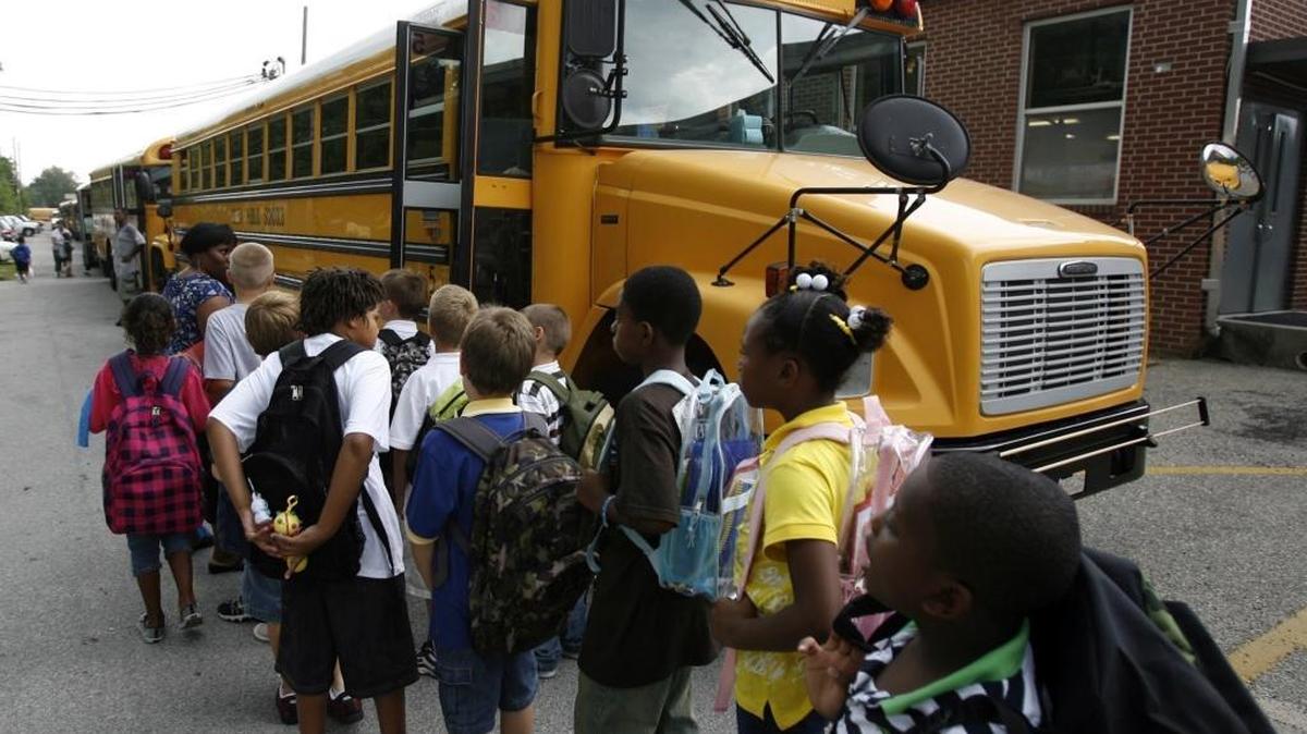 Popp’s Ferry Elementary School students in Biloxi prepare to load on to the school buses in 2009