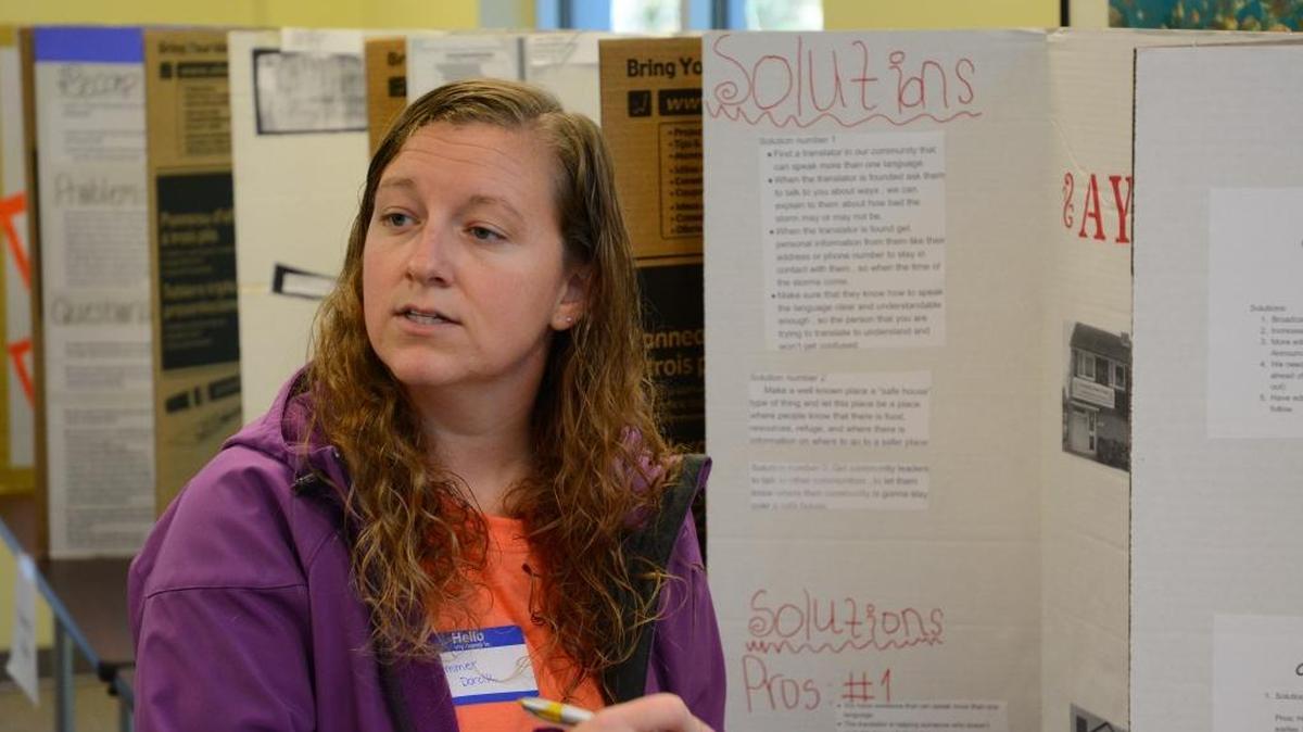 Gulf Coast Research Laboratory Marine Education specialist Summer Dorcik examines student projects to determine winners of the Watershed Education and Training Program that Pascagoula and Gautier High School students participated in on Thursday.