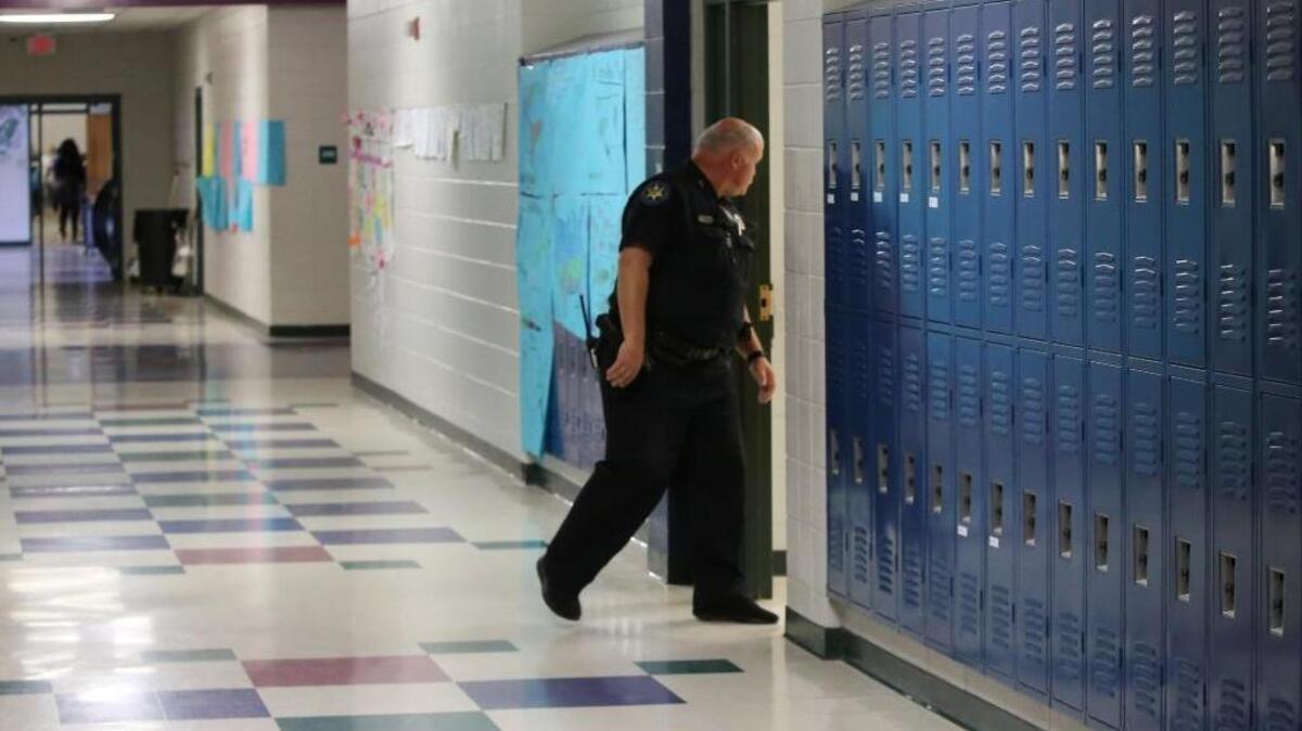 Harrison County Sheriff's Deputy Walter Eighmey checks classrooms at West Wortham Elementary & Middle School on Friday, Feb. 23, 2018. Eighmey has been a school resource officer at the school for 10 years.