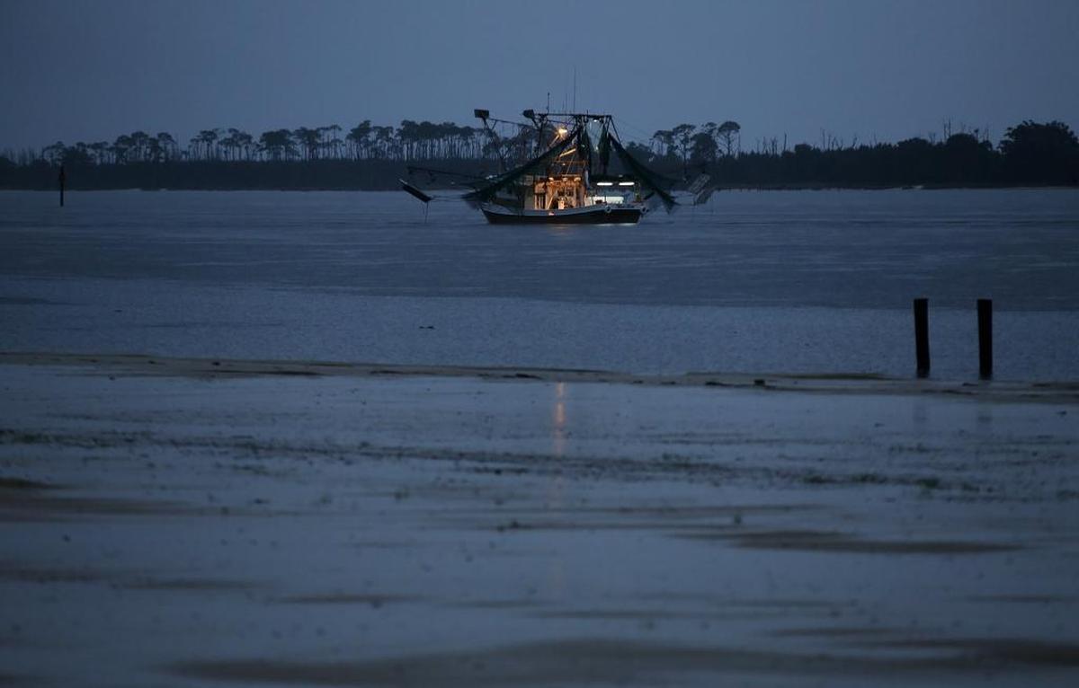Shrimp boats hug the shore in Biloxi on Tuesday evening, June 6, 2017, before heading to open water in anticipation of the opening day of shrimp season. Shrimp season in Mississippi opened on June 7. Photographer’s comments: Shrimp and oyster boats are some of my favorite things to shoot on the Coast. I also love shooting at dusk. This photograph combined both of those things.