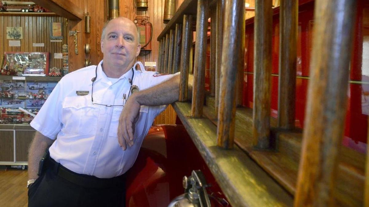 Chief Joe Boney leans on a ladder of an antique fire truck at West End Fire Co. No. 3 Fire House Museum in Biloxi.