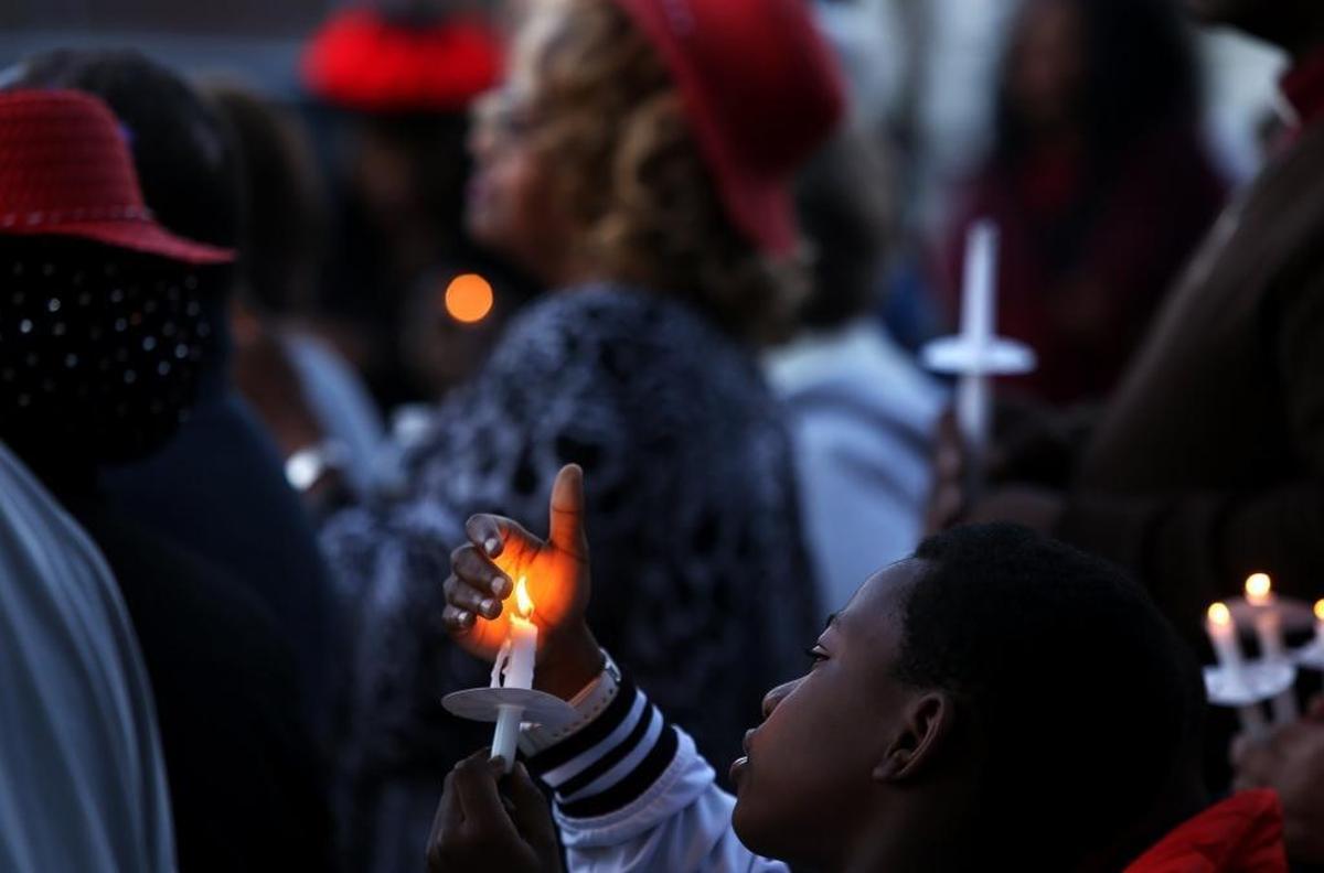Exavier Wiggins, 9, of Biloxi attends a vigil on Sunday, March 12, 2017, at Doris L. Busch Park in Biloxi for the victims of the charter bus that was struck by a CSX freight train at the Main Street crossing earlier that week. Photographer’s comments: I love the composition of this photo, particularly the way that Exavier Wiggins is looking up at the candle and how the flame is sheltered by his hand.