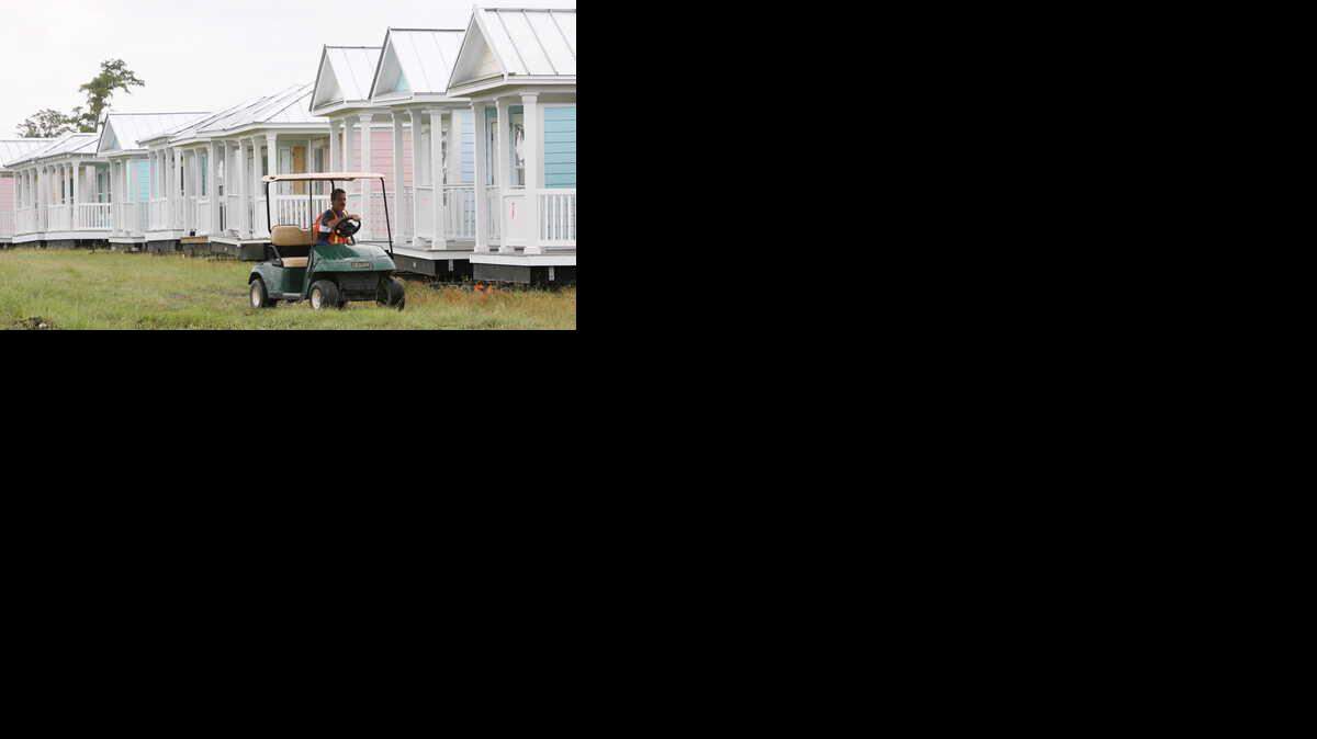 Scott Hughes of Kiln drives past a row of MEMA cottages Monday at the cottage staging facility on Landon Road in Gulfport in August 2008.