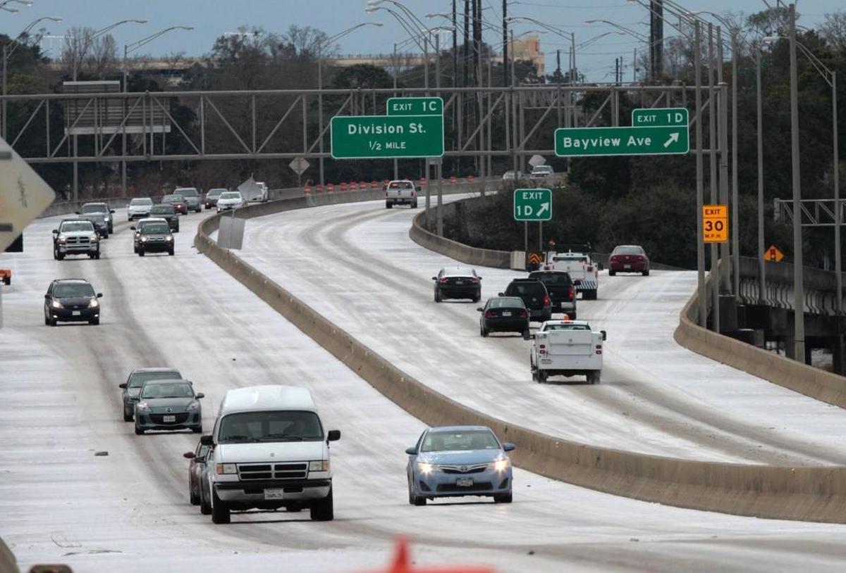 Motorists make their way along I-110 in Biloxi on Wednesday Jan. 29, 2014, after a winter storm left ice on most South Mississippi roads.