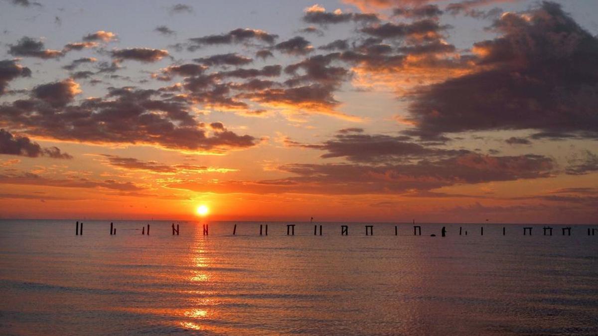 A sunrise showcases the beauty of the Mississippi Sound, where many people would like to see BP economic damages money spent.