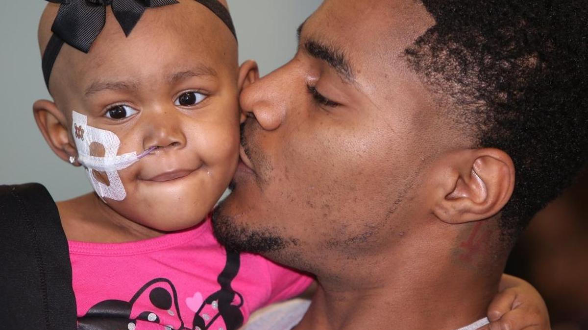 Ryan Rainey gives his daughter, Saniya, 3, a kiss as they wait to check in at Gulfport-Biloxi International Airport before leaving for a Make-A-Wish trip to Disney World on Friday, Oct. 14, 2016. Saniya was diagnosed with cancer two years ago.
