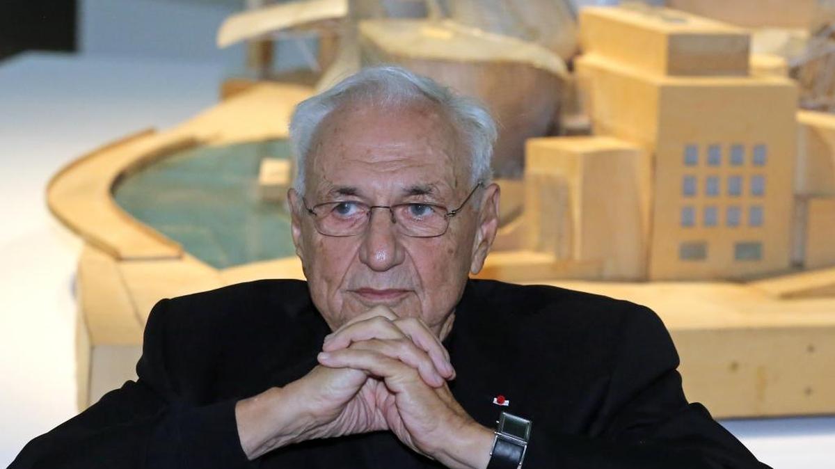 Architect Frank Gehry sits in front of a model of The Guggenheim Museum in Bilbao, Spain.