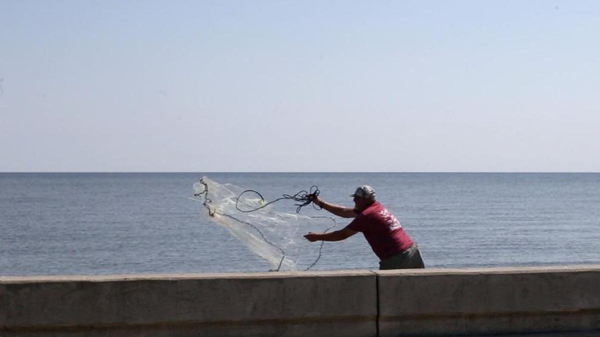 A fisherman tosses a cast net into the Mississippi Sound in Clermont Harbor near where Ronald ‘Griz’ Winnert of Waveland was fishing when he came into contact with seawater and was infected with the vibrio bacteria. People with weak immune systems should avoid contact with the Sound.