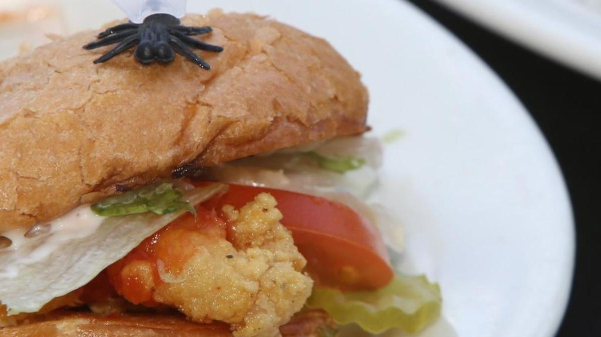 A namesake plastic fly sits on a po-boy at the Blow Fly Inn in Gulfport. The iconic restaurant’s ‘re-grand opening’ was held Friday.