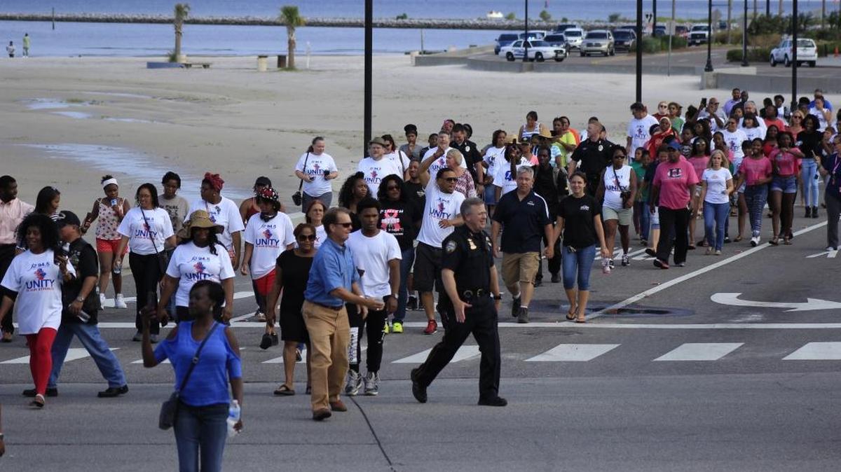 People march from Jones Park to the Gulfport Police Department as part of a rally against violence on Friday.