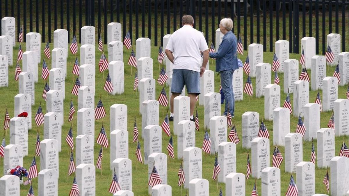 Families visit graves of loved ones after Memorial Day ceremony at Biloxi National Cemetery, Monday, May 29, 2017.