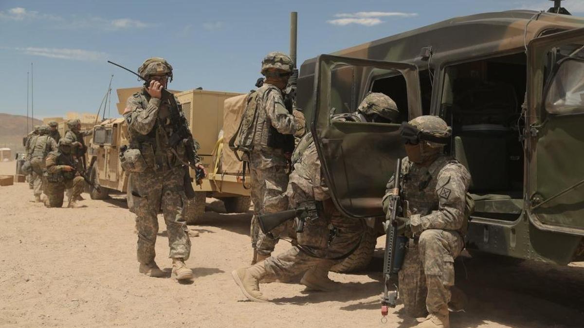 U.S. Army Soldiers assigned to 155th Brigade Combat Team, Mississippi National Guard, react to a simulated SCUD missile attack by establishing a secure position around a HMMWV during Decisive Action Rotation 17-07 at the National Training Center in Fort Irwin, Calif., May 25, 2017.