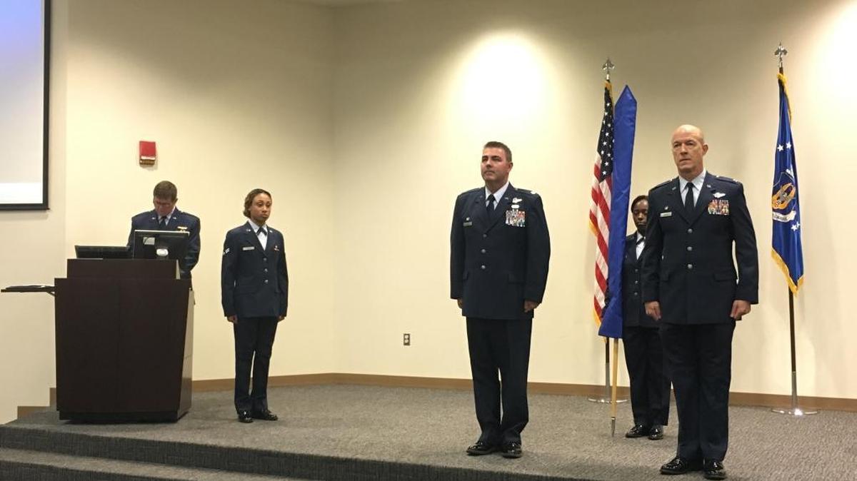 Lt. Col. Brian May, center, and Col. Thomas Hansen, right, participate in a redesignation ceremony for the 36th Aeromedical Evacuation Squadron at Keesler Air Force Base on Saturday, Oct. 15, 2016.