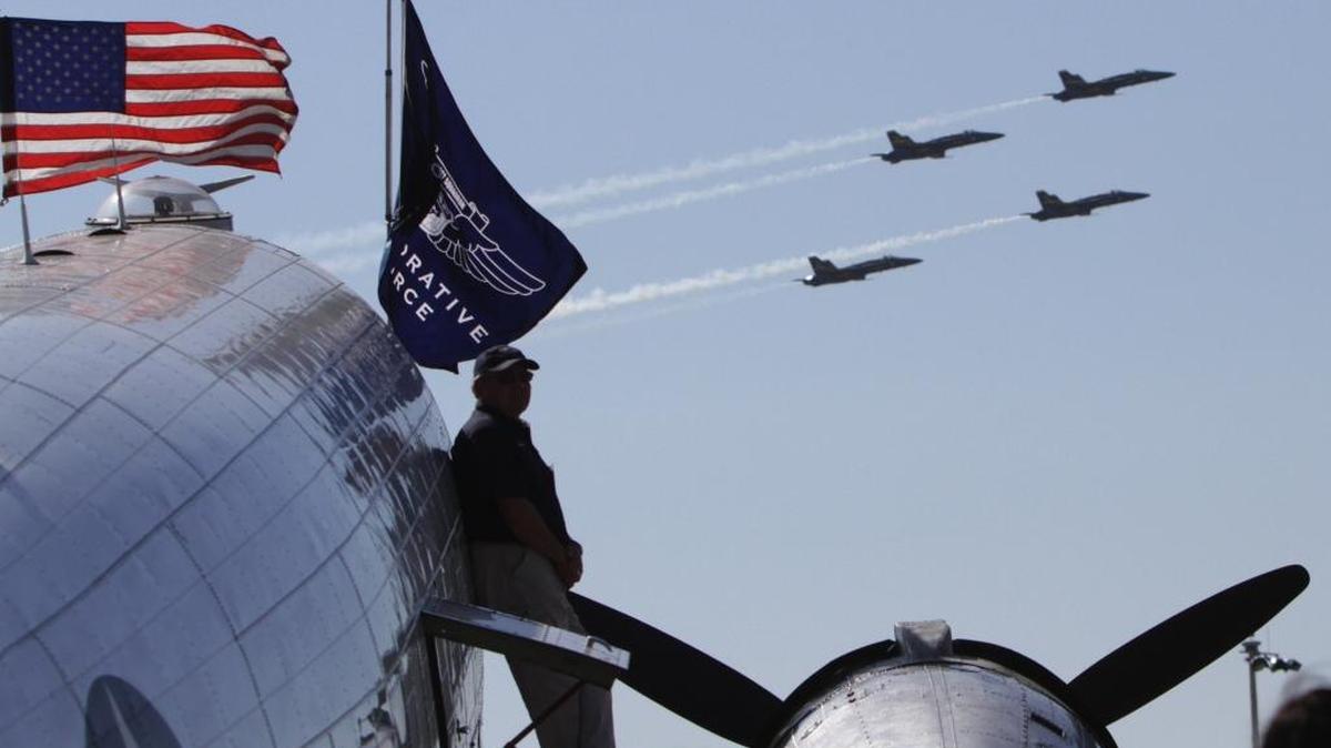 A pilot watches the Blue Angels perform from the wing of the Highland Lakes Squadron's 1944 C-47 Skytrain during the 2011 Keesler Air Force Base airshow in Biloxi. With an Air Force pilot shortage that has hit 2,000, and commercial airlines in a hiring boom, service leaders are brainstorming ways to address a deepening crisis, eyeing improved financial incentives and a host of administrative actions to improve quality of life for aviators and their families.