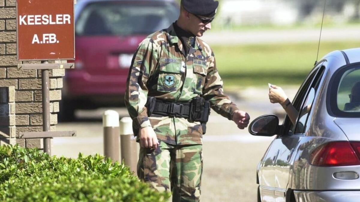 An airman checks identification at the Pass Road gate at Keesler Air Force Base in 2001. Congress should revise the rules guiding base realignment and closure and authorize a new round, a new paper from a conservative think tank recommended.