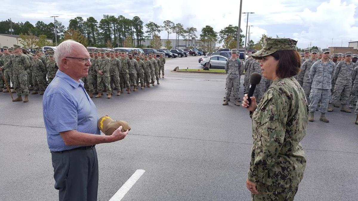 Current NCTC Commander Ana Franco, right, presents first NCTC Commander J.B. Leap with a commemorative baseball cap during NCTC's 50th anniversary ceremony.