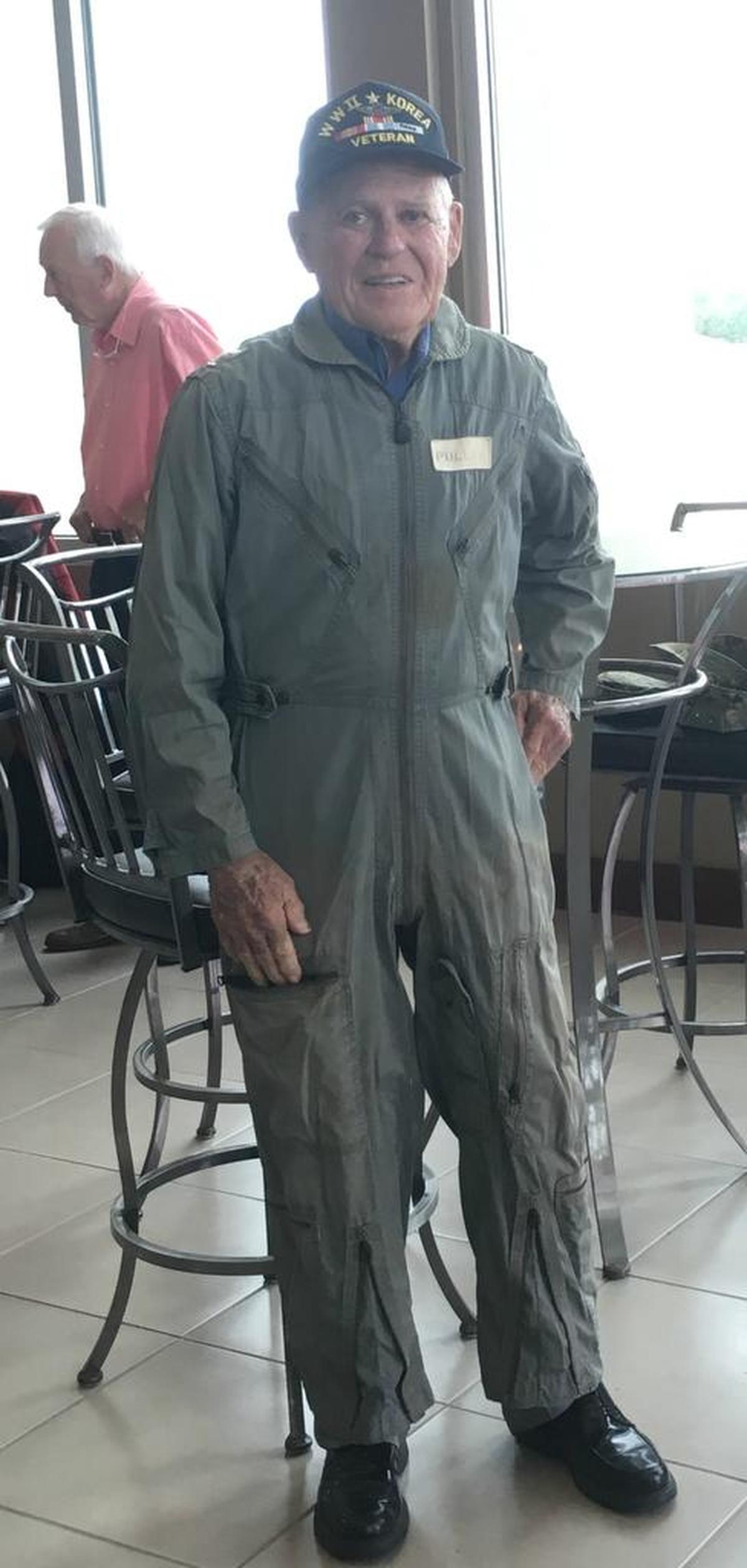 Ed Pullis proudly wears the flight suit he wore during his last years of active duty service in the U.S. Air Force. Pullis was one of eight Seashore Highlands Retirement Community residents who took flights in a World War II-era biplane on Wednesday.