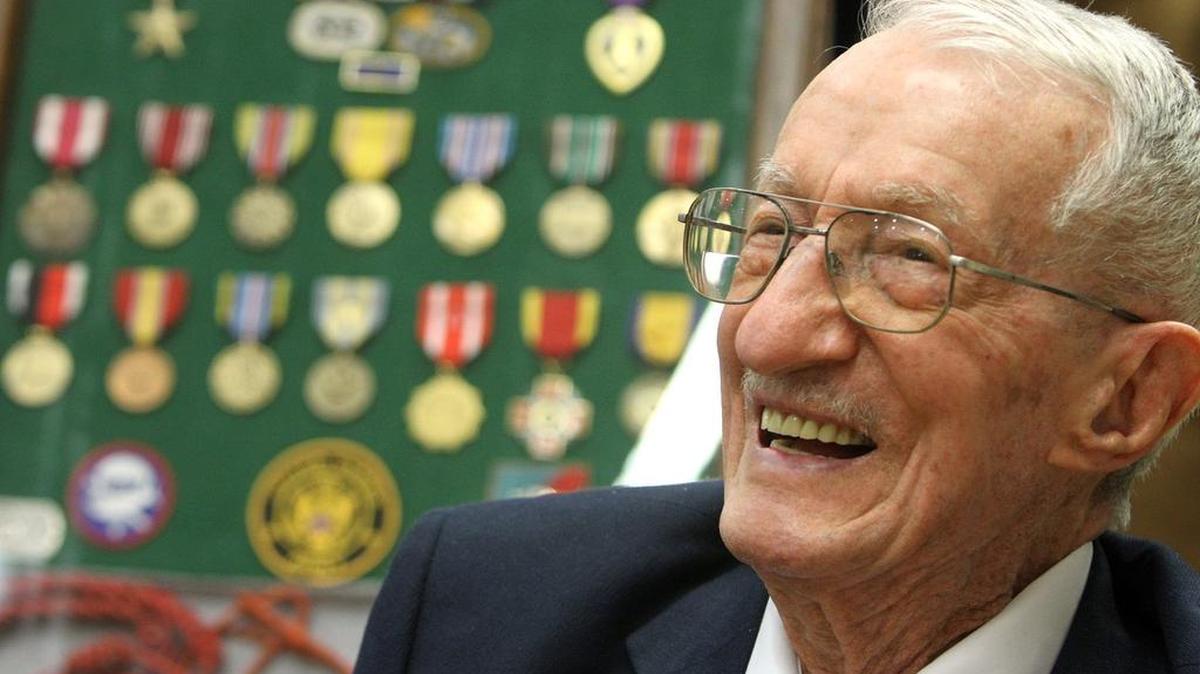 WWII veteran Adelchi Pilutti greets well-wishers before a ceremony honoring him at the Ocean Springs Community Center on Friday March 6, 2015.