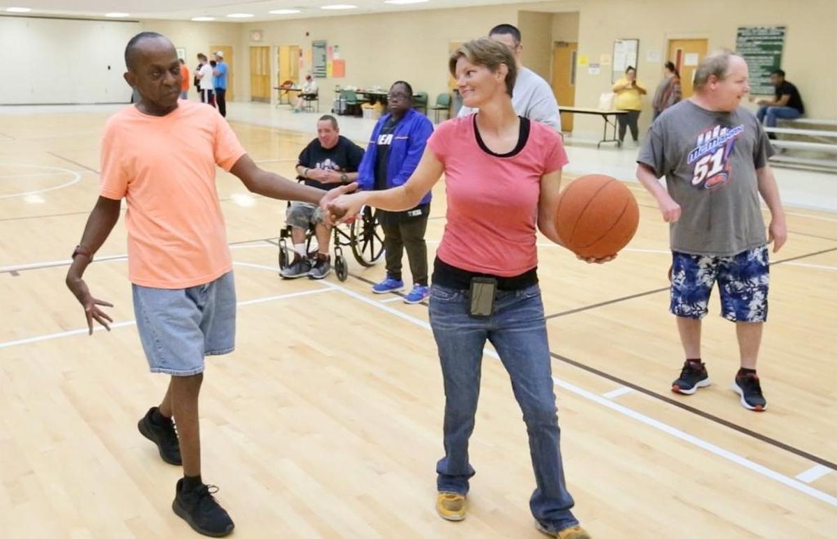 Olina Nelson of Biloxi leads David McClelland to the basket to take a shot during the City of Biloxi’s special needs basketball program at the Donal Snyder Community Center in Biloxi on Tuesday, July 25, 2017. Photographer’s comment: Nelson, herself mother to special needs children, pours herself into this program. She gives the participants love and patience and they give her love in return.