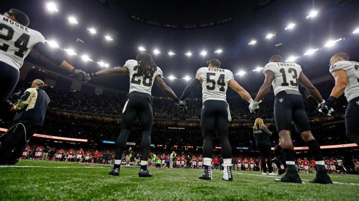 New Orleans Saints and Atlanta Falcons players form a unity demonstration on the field before an NFL football game in New Orleans, Monday, Sept. 26, 2016.