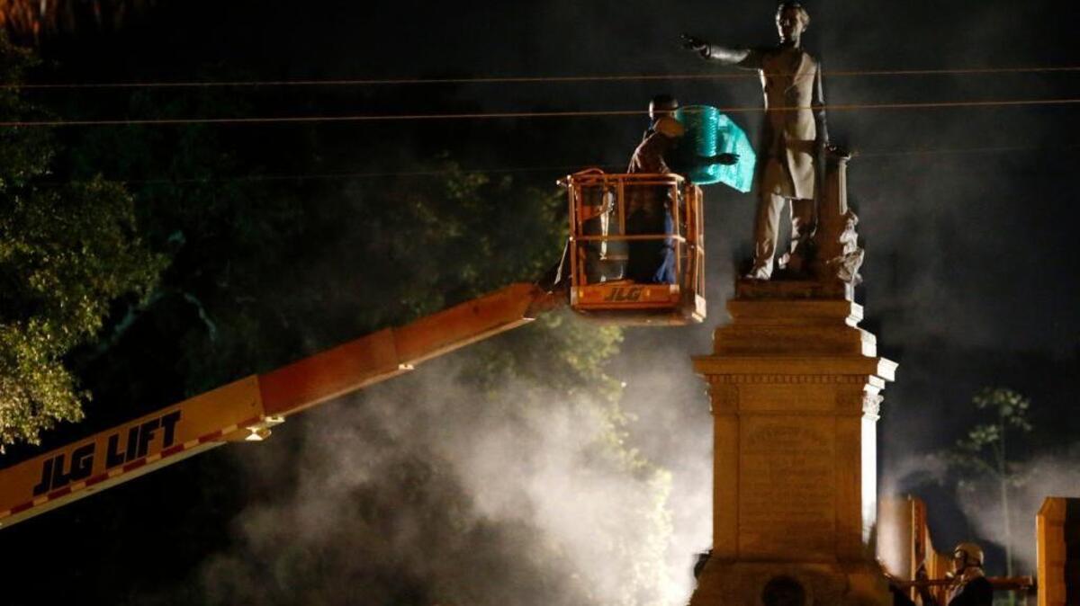 Workers prepare to take down the Jefferson Davis statue in New Orleans, Thursday, May 11, 2017. This was the second of four Confederate monuments slated for removal in a contentious process that has sparked protests on both sides.