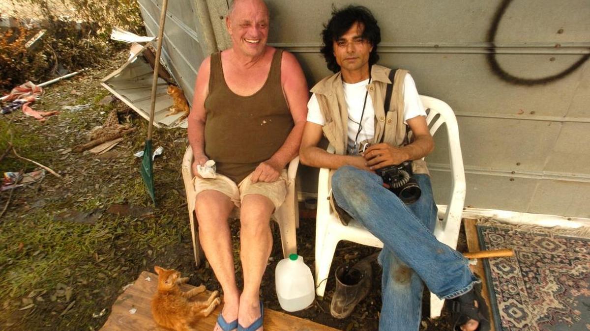 Photojournalist Nick Oza, who came from Macon, Georgia, to help the Sun Herald staff in Hurricane Katrina’s aftermath, visits with a survivor and his cat. Oza is currently covering Hurricane Harvey’s aftermath in southeast Texas for Gannett.