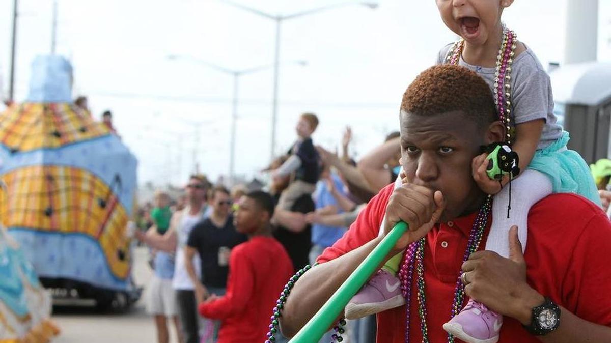 William Faucett of Bay St. Louis and his daughter, Jade, 2, call for throws during the Krewe of Nereids Mardi Gras parade in Waveland on Sunday Jan. 31, 2016