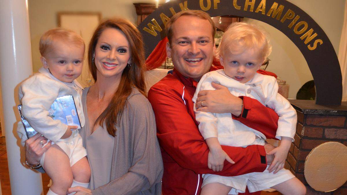 Trinity and Scott Walker hold their children, Max, left, and Wren on the occasion of Max's second birthday. They chose a Hotty Toddy Ole Miss theme for the party.