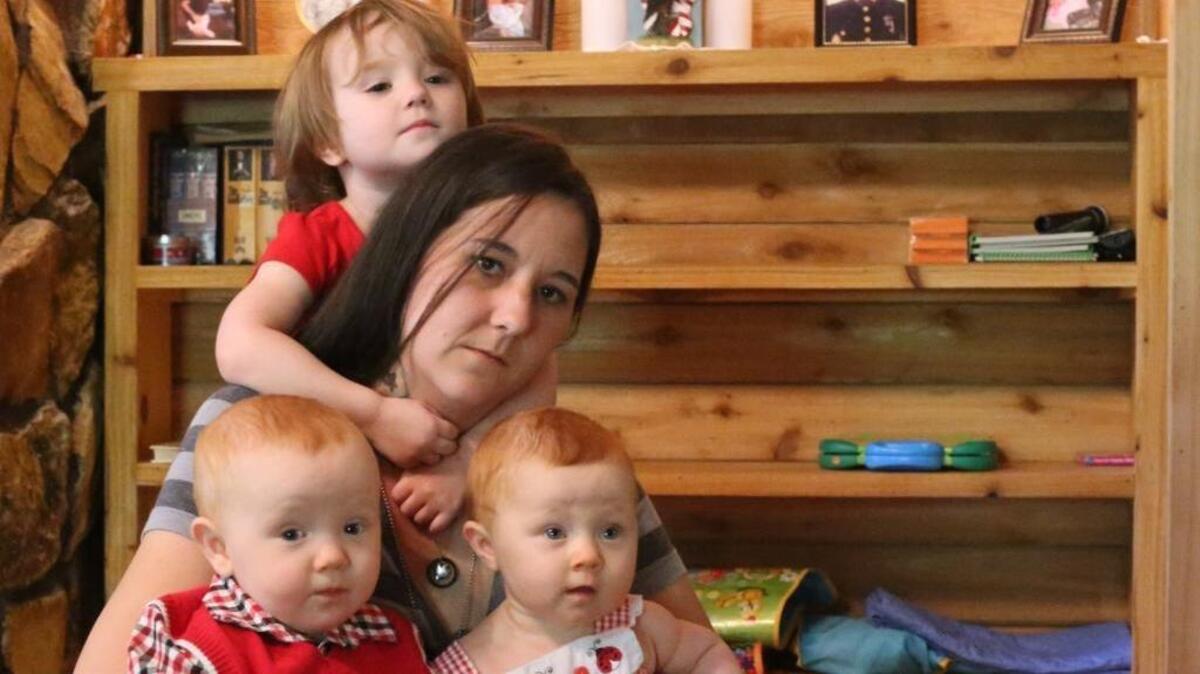 Jamie Lee of Saucier, with her daughter, Alana, 2, and twin 9-month-olds, Hunter and Hailey, is struggling to get Veterans Affairs benefits after her husband, Hank Lee, a Marine veteran, died in March. The cause of Hank Lee's death, who was being treated for post traumatic stress disorder and traumatic brain injury, is still unknown.