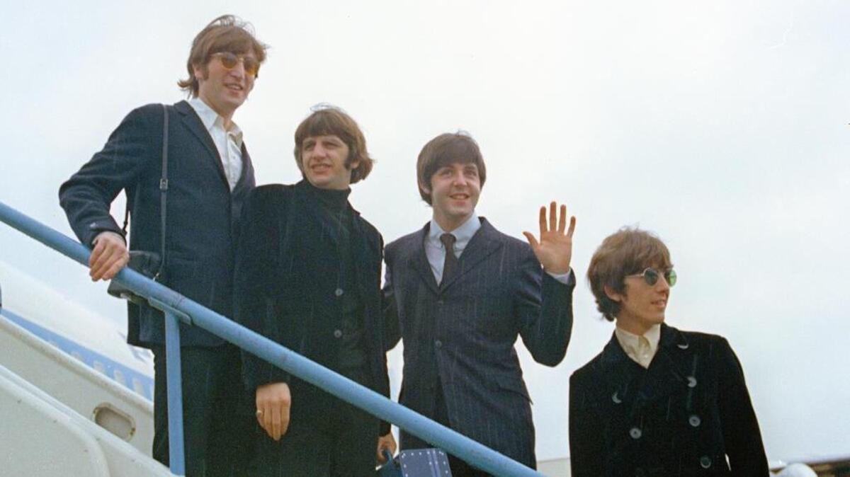 This 1966 photo shows The Beatles — John Lennon, left, Ringo Starr, Paul McCartney and George Harrison — as they leave London on their trip to the U.S. and Canada.