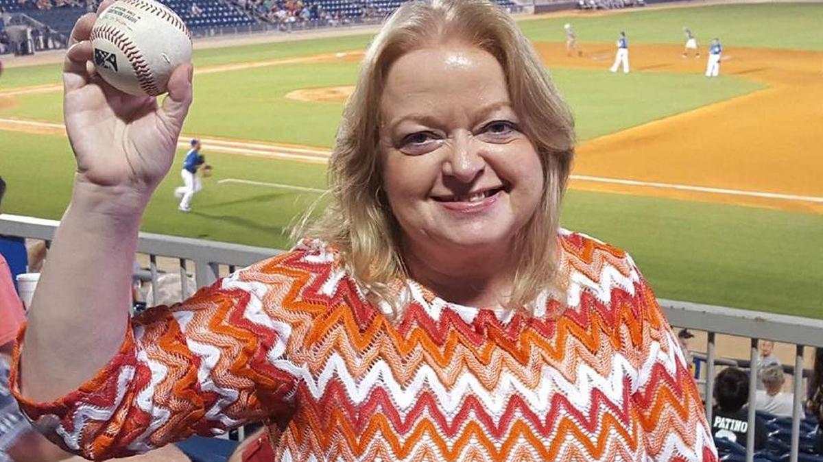 I hold the baseball that landed in my cup holder at MGM Park on Aug. 23.