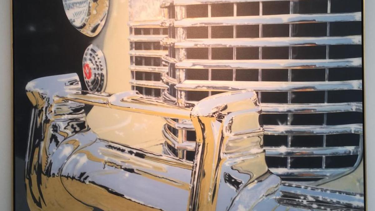 ‘Cadillac Bumper Section’ by Clarence Measelle is an example of photorealism. The work is part of the ‘Cars in Art II’ exhibition at the Ohr-O’Keefe Museum of Art in Biloxi.