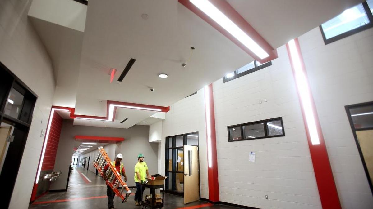 Construction crews bustle around Biloxi Junior High School to complete work on the building as teachers move in their classrooms in preparation for the new school year on Thursday, July 27, 2017. The state-of-the-art 95,000-square-foot building will hold up to 1,300 7th and 8th graders.