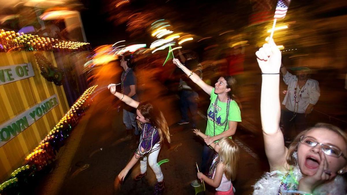 Parade goers yell for throws as the Carnival Association of Long Beach parade rolls on Saturday, February 18, 2017, in Long Beach.