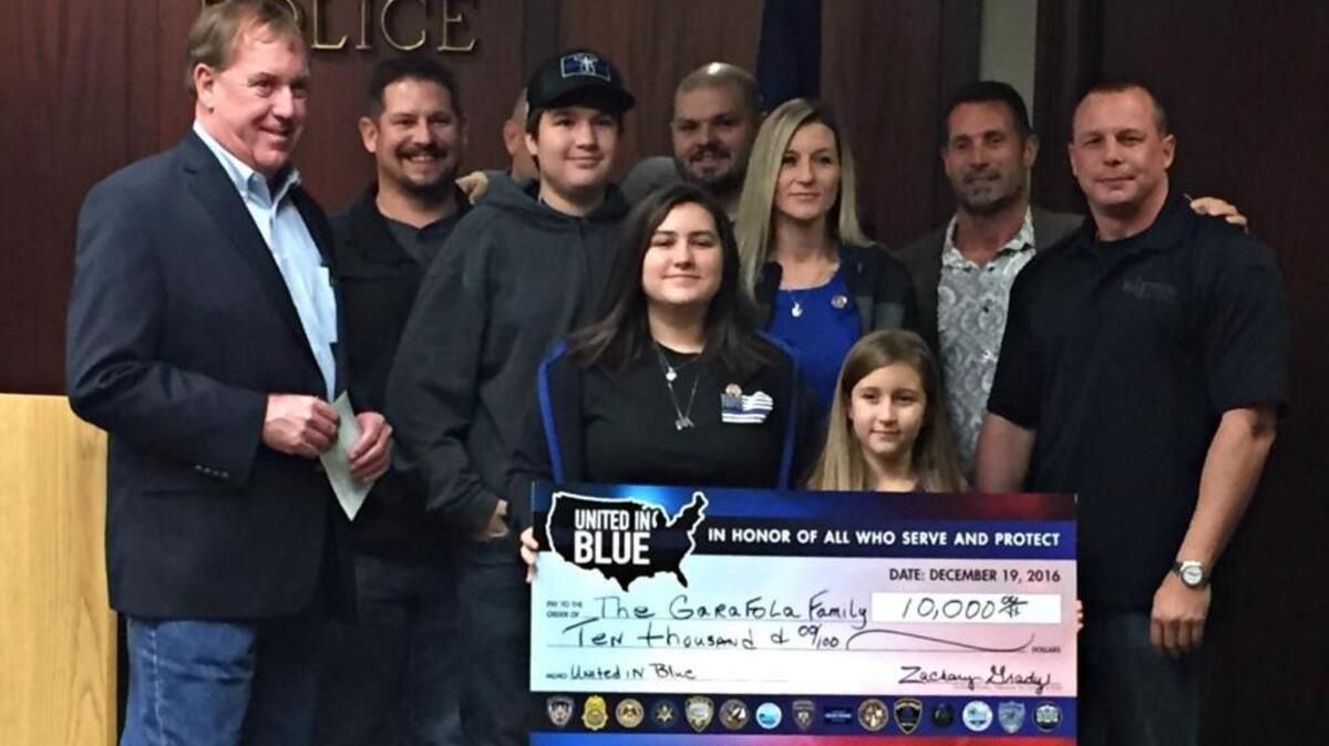 The Garafola family receives a check from United in Blue, a fundraiser that showed South Mississippi’s support for the fallen and injured police officers in the July ambush in Baton Rouge. Deputy Brad Garafola died in the shooting.