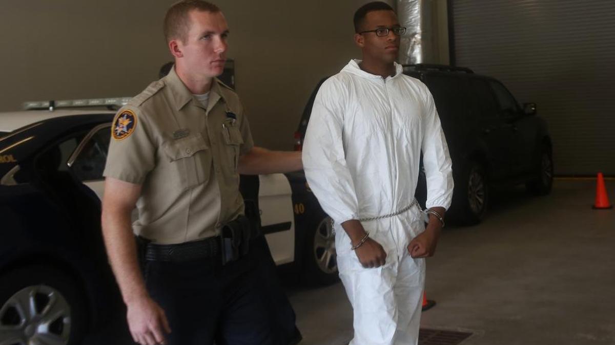 Dwanya Hickerson, 20, is led into the Jackson County jail on Monday, July 25, 2016. Dickerson is accused of robbing and killing Dee Whigham, a 25-year-old transgender woman who was visiting the Coast for Black Rodeo.