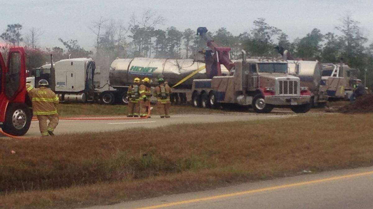Firefighters and DEQ employees work to clean up a hazardous materials spill on Mississippi 607 in Hancock County, north of Interstate 10 on Thursday, after the initial incident closed part of I-10 for several hours Wednesday night.