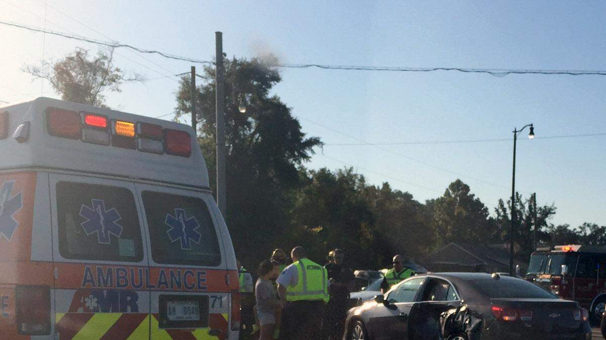 First responders at the scene of a two-car collision at the foot of Kremer Bridge at Magnolia Street and Cowan Road on Friday morning. The incident caused traffic delays in the northbound lanes.