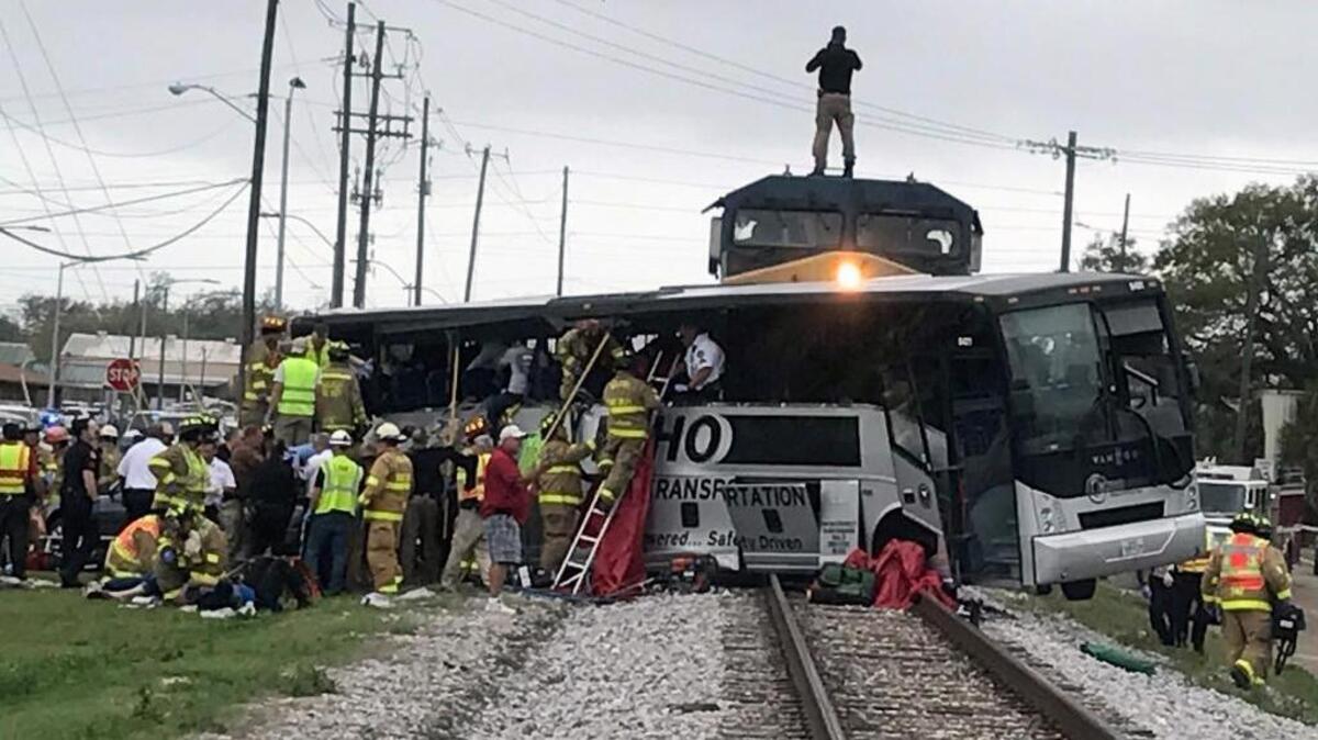 Biloxi firefighters help passengers of a charter bus out after the bus collided with a train in Biloxi on Tuesday afternoon.