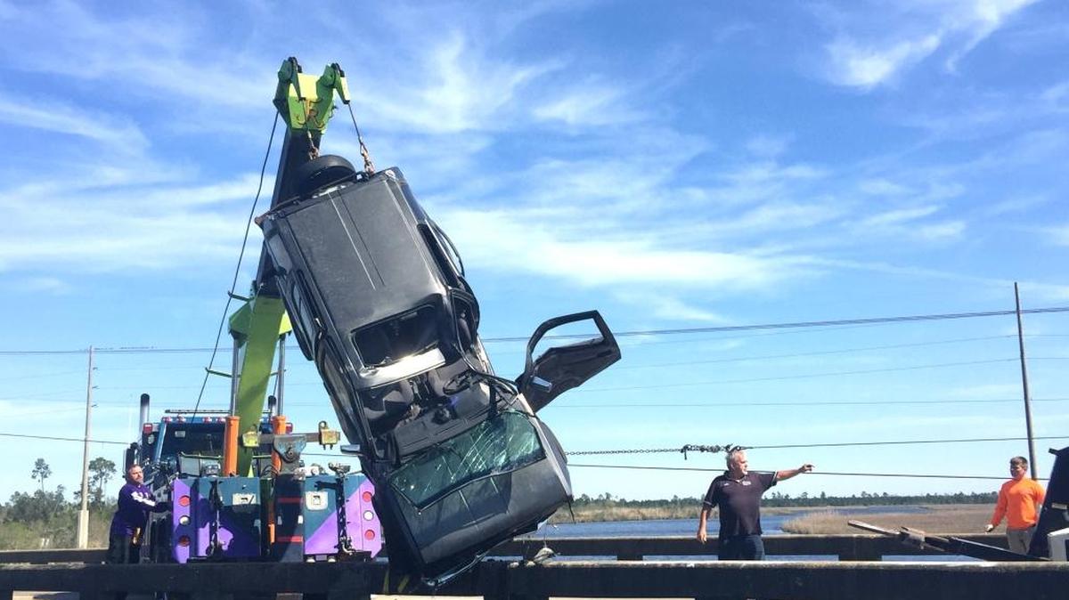 A Nissan Pathfinder is pulled from Bayou LaCroix in Bay St. Louis on Saturday after its driver crashed through the concrete guard rail and into the water. Northbound lanes of Mississippi 603 were blocked for more than an hour as crews worked to get the SUV out of the bayou.