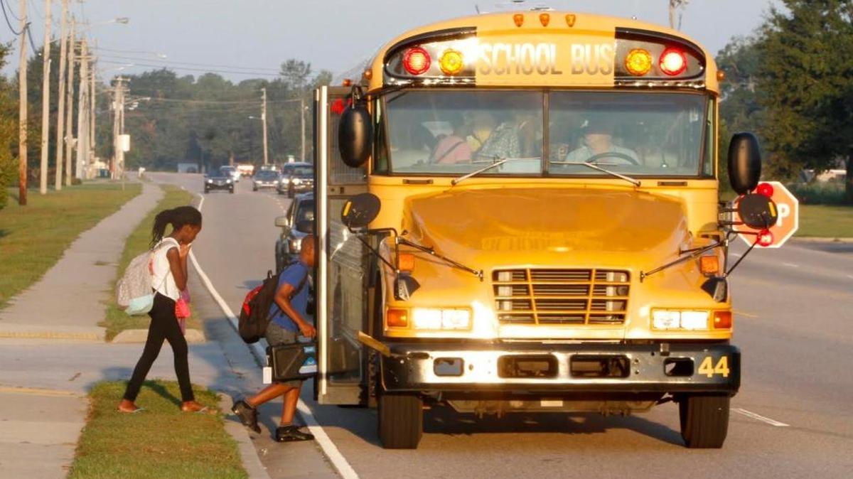 Two students board their school bus on Popps Ferry Road in Biloxi, Wednesday, Sept. 9, 2015.