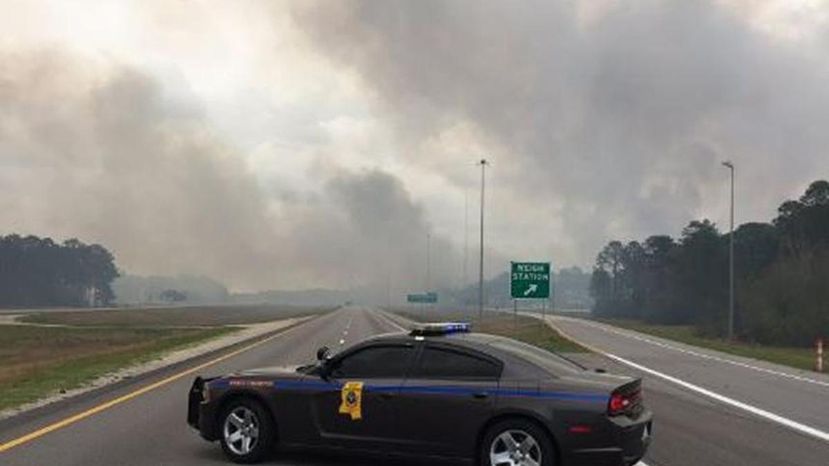 Interstate 10 near the Mississippi-Alabama state line is closed due to a woods fire causing smoke to billow over the roadway.