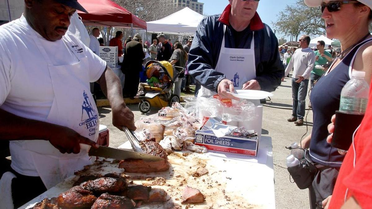 Members of the Biloxi City Council cooking team serves up some barbecue during a previous Grillin’ on the Green.