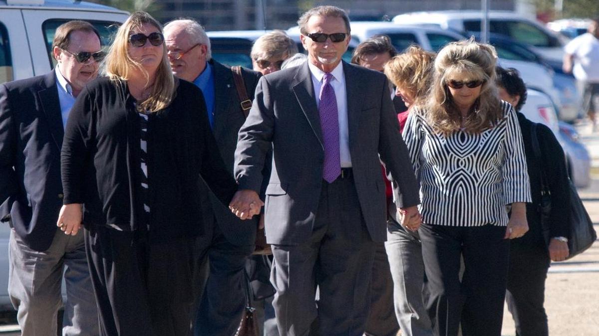 Kim Savant arrives at the federal courthouse in Gulfport with his family on the day he pleaded guilty to a criminal conspiracy charge in December 2014.