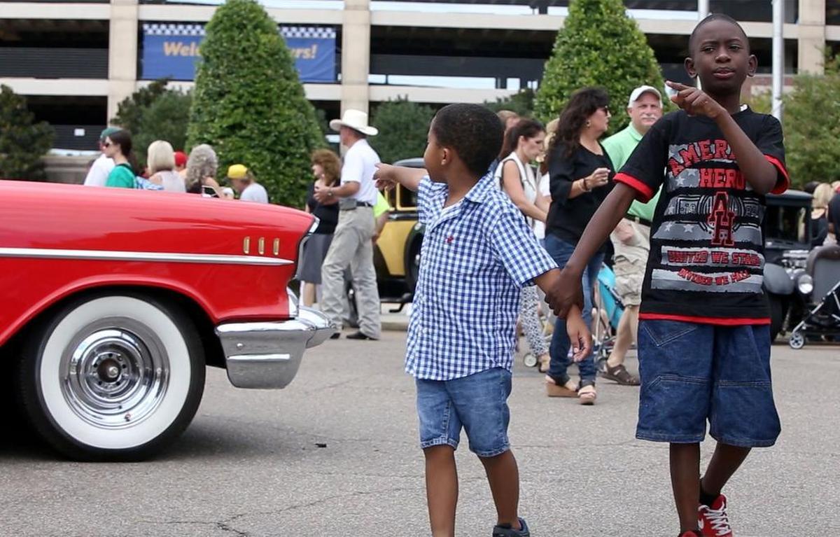 Kaiden Myles, 6, and his brother, Zavier, 10, of Lavadieville, La., look at the classic cars during Gulfport's View The Cruise on the first day of Cruisin' The Coast on Sunday, Oct. 2, 2016.