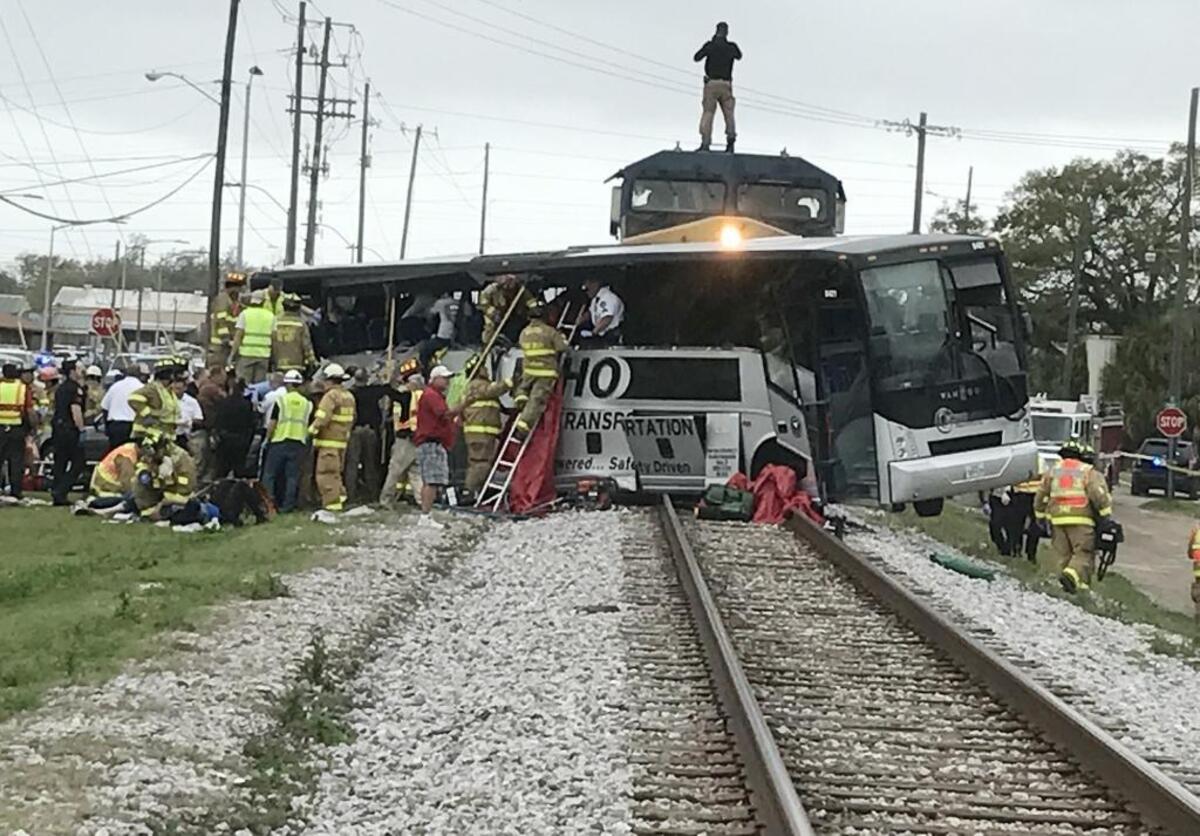 Rescue personnel work to remove passengers from a charter bus that was hit by a CSX train at the Main Street crossing in Biloxi, Miss., on March 7, 2017.