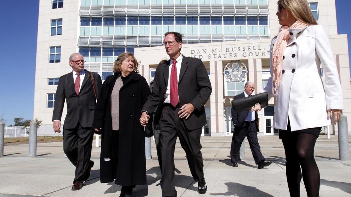 Bill Walker, center, leaves U.S. District Court in Gulfport in 2013 with wife Sharon, attorney Bill Kirksey, left, and daughter-in-law Trinity Walker, right.